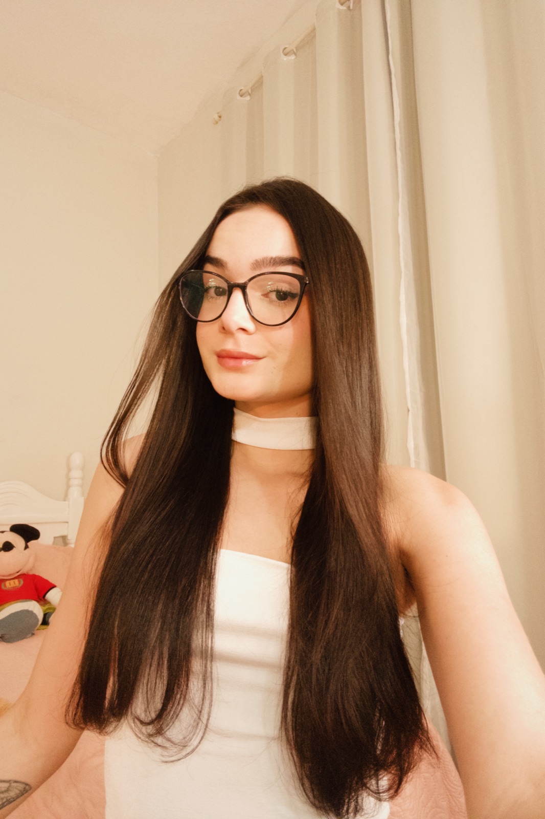 Sarah wearing glasses in a warm portrait